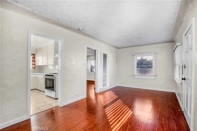 a view of a kitchen with wooden floor and a kitchen