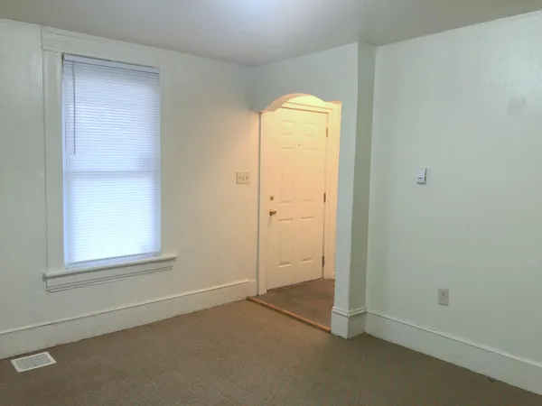 an empty room with windows and closet