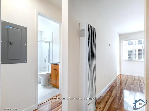 a bathroom with a granite countertop sink a toilet and bathtub
