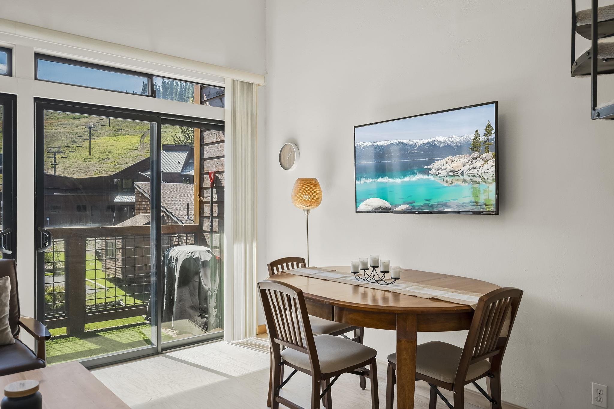 11591 Snowpeak Way, Unit 407 Truckee, CA 96161 - Photo 11 of 21 a dining room with furniture and a floor to ceiling window