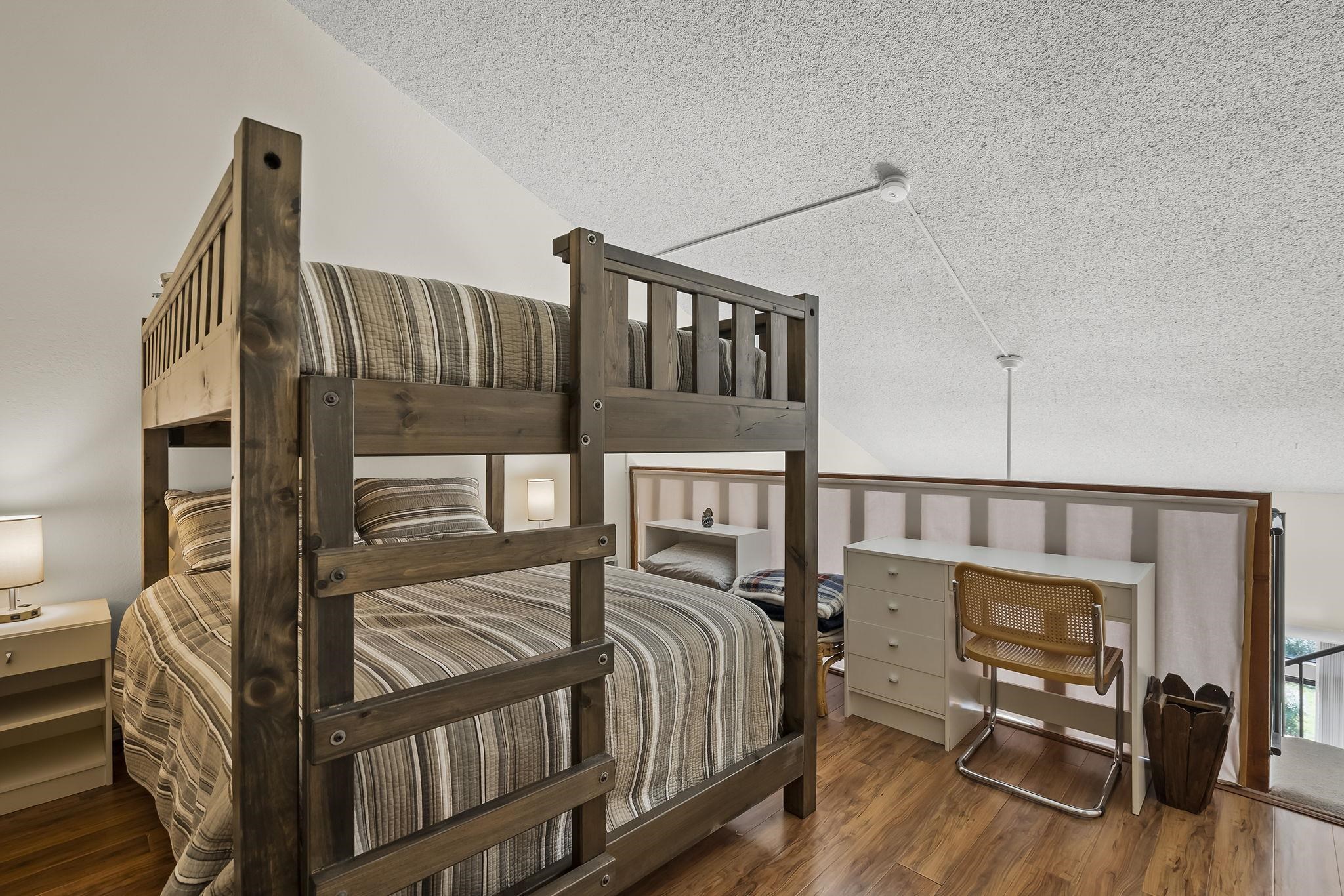 11591 Snowpeak Way, Unit 407 Truckee, CA 96161 - Photo 14 of 21 a bedroom with a bed next to a large window