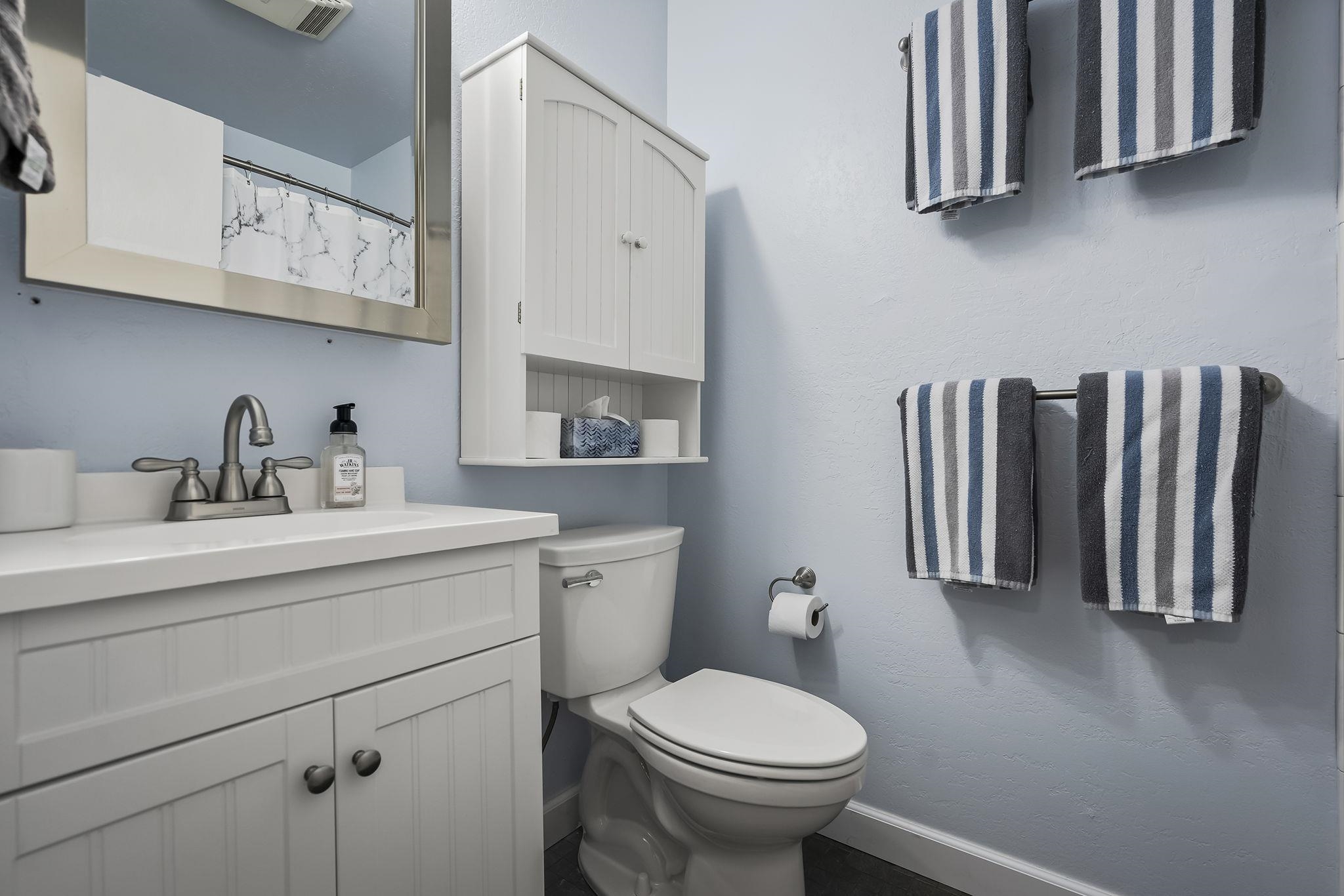 11591 Snowpeak Way, Unit 407 Truckee, CA 96161 - Photo 16 of 21 a bathroom with a sink a toilet and mirror