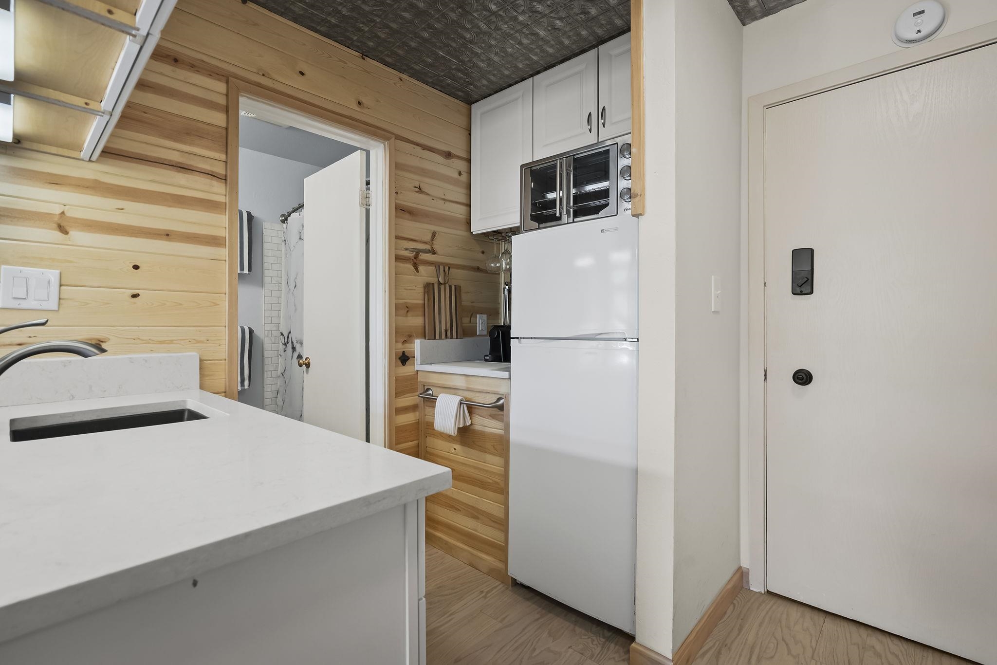 11591 Snowpeak Way, Unit 407 Truckee, CA 96161 - Photo 9 of 21 a kitchen with refrigerator and microwave