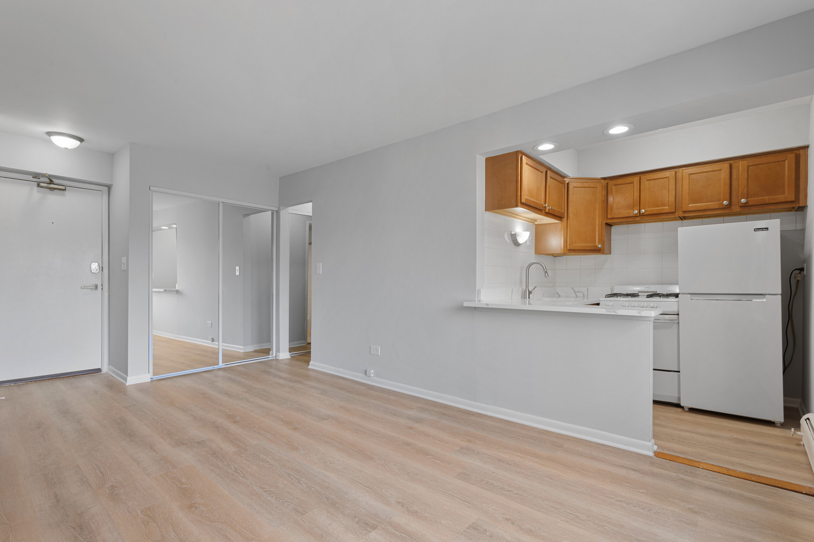 6758 North Sheridan Road, Unit 247 Chicago, IL 60626 - Photo 4 of 13 a view of a kitchen with a sink and a refrigerator