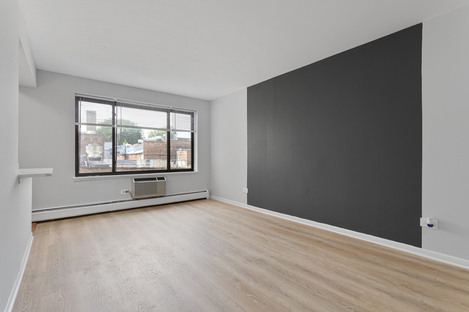 6758 North Sheridan Road, Unit 247 Chicago, IL 60626 - Photo 6 of 13 an empty room with wooden floor and windows