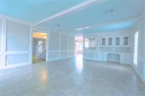 a view of an empty room with a fireplace and a window