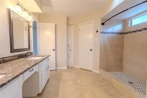a bathroom with a granite countertop sink a mirror a shower and a bathtub