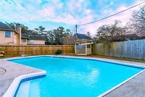 a view of a backyard with swimming pool