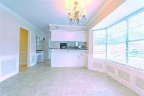 a view of a room with window and chandelier