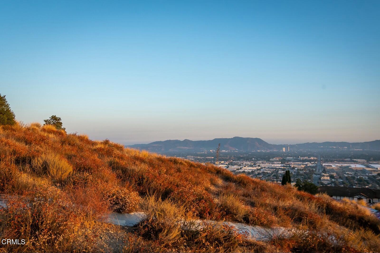 9999 Edmore Place Sun Valley, CA 91352 - Photo 13 of 22 a view of a large building with mountains in the background