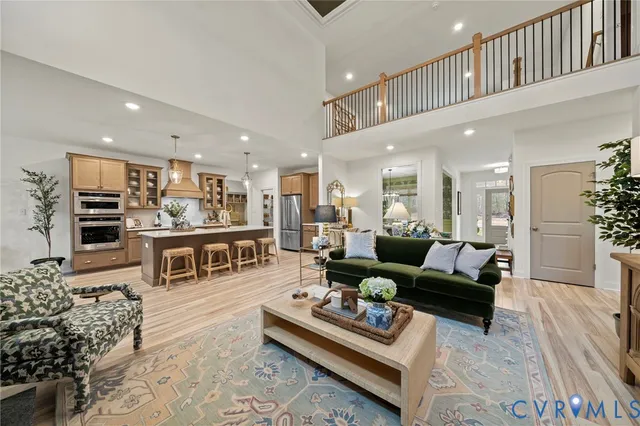a living room with furniture kitchen view and a table