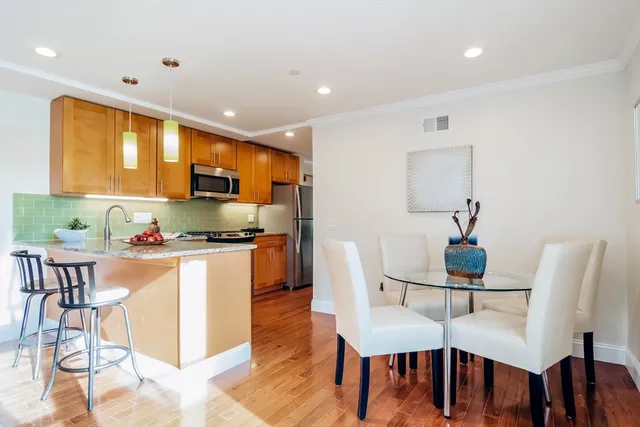 a view of a dining room with furniture and wooden floor