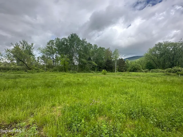 a backyard of a house with a yard and outdoor seating