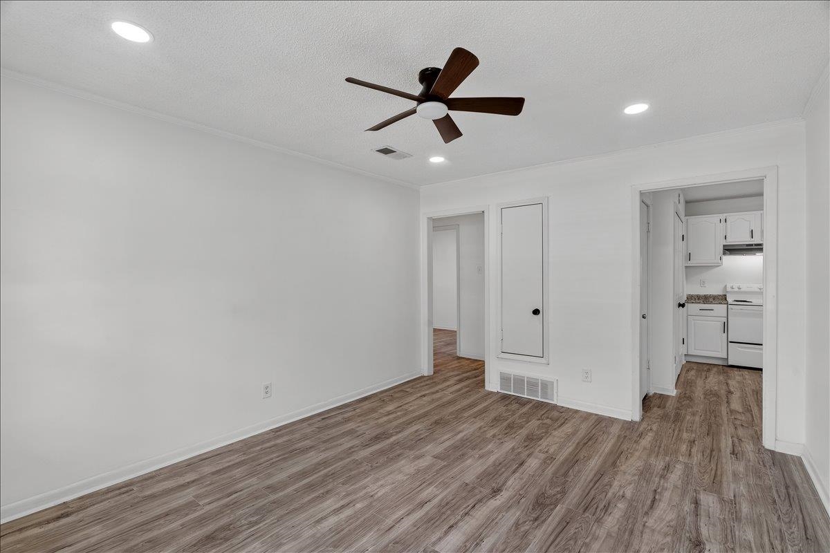 2717 Merle Street Memphis, TN 38118 - Photo 5 of 18 Spacious room featuring wood-finish flooring, white walls, and recessed lighting