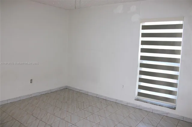 a view of a room with white walls