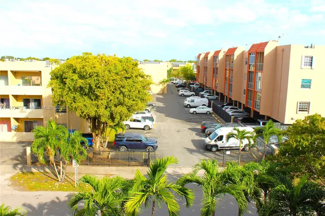 a view of a swimming pool with a lawn chairs and a yard
