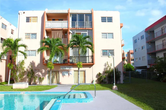 a front view of multiple houses with yard
