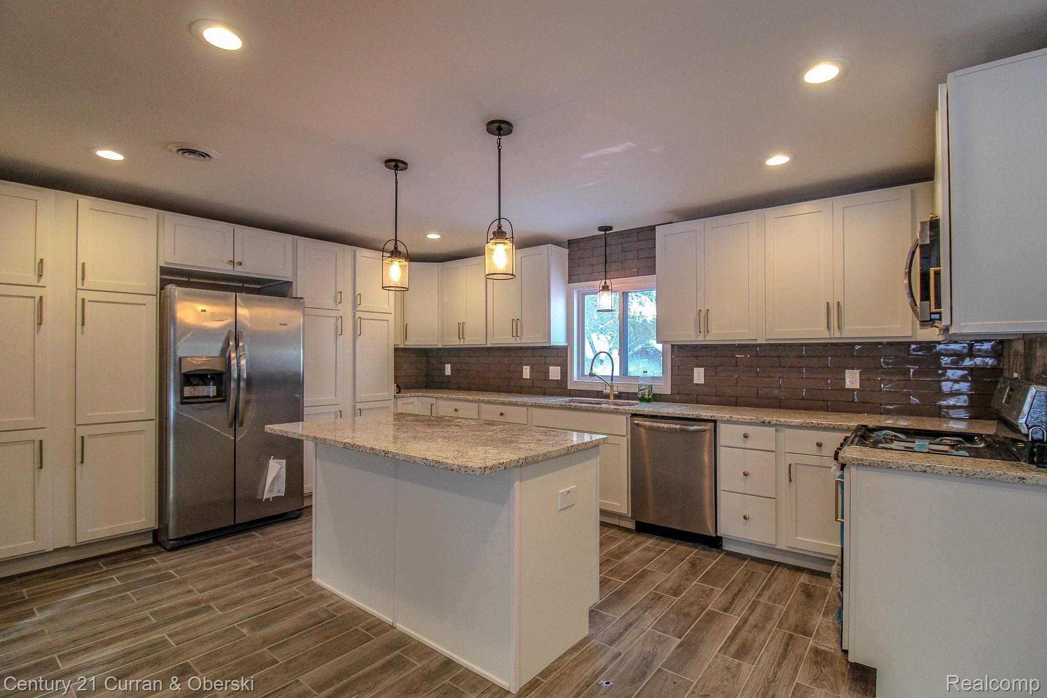 updated 2019 beautiful kitchen with granite counters, large center island & stainless steel appliances.