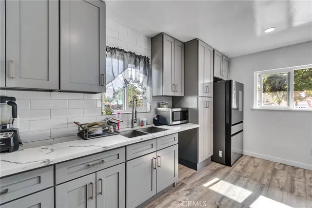 a kitchen with stainless steel appliances granite countertop a refrigerator sink and cabinets