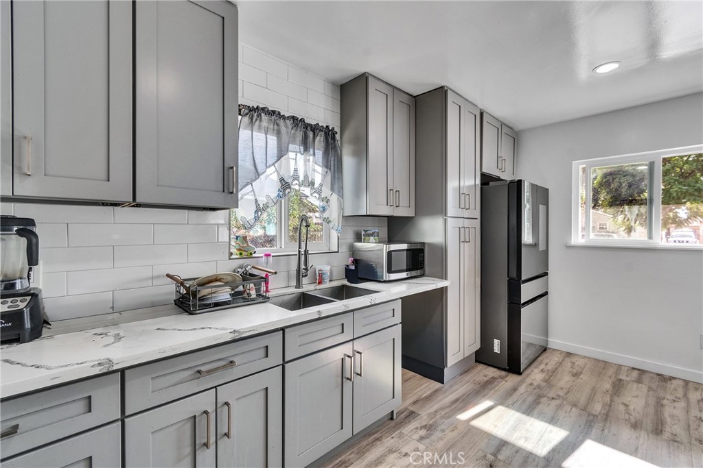 5121 Sierra Street Riverside, CA 92504 - Photo 17 of 34 a kitchen with stainless steel appliances granite countertop a refrigerator sink and cabinets