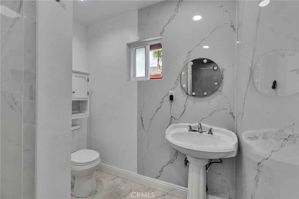 5121 Sierra Street Riverside, CA 92504 - Photo 22 of 34 a bathroom with a sink toilet and mirror