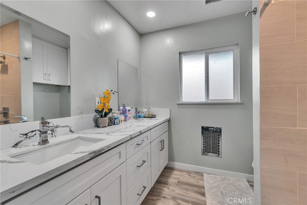 5121 Sierra Street Riverside, CA 92504 - Photo 24 of 34 a bathroom with a double vanity sink and a mirror