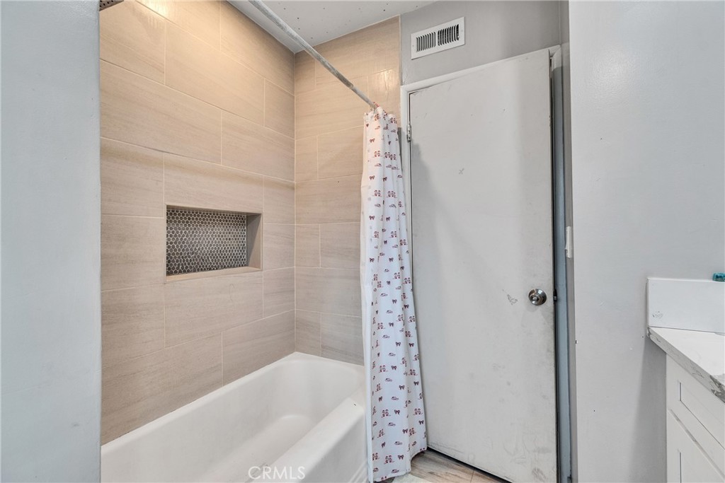 5121 Sierra Street Riverside, CA 92504 - Photo 25 of 34 a bathroom with a bathtub and shower