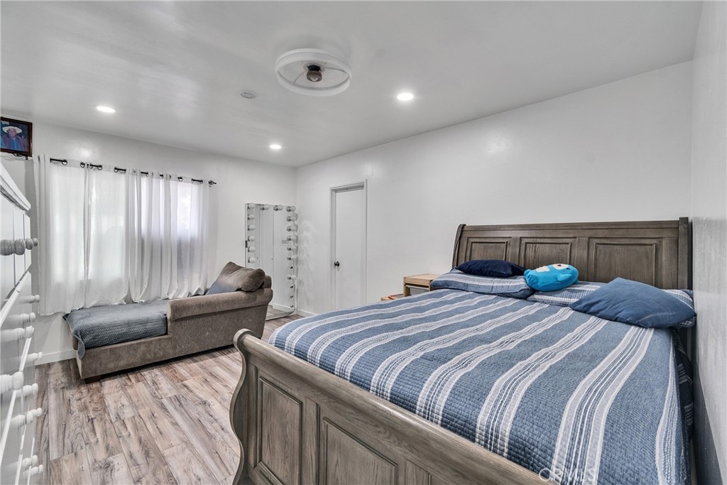 5121 Sierra Street Riverside, CA 92504 - Photo 28 of 34 a bedroom with a bed and a couch