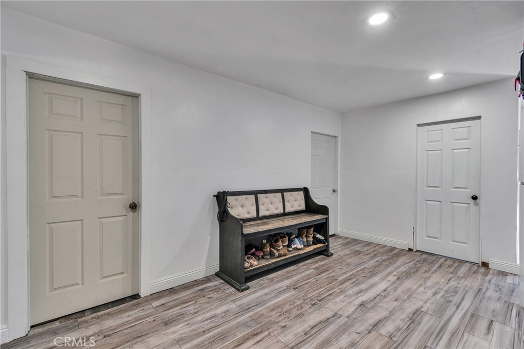 5121 Sierra Street Riverside, CA 92504 - Photo 33 of 34 a view of a hallway with wooden floor and white cabinet