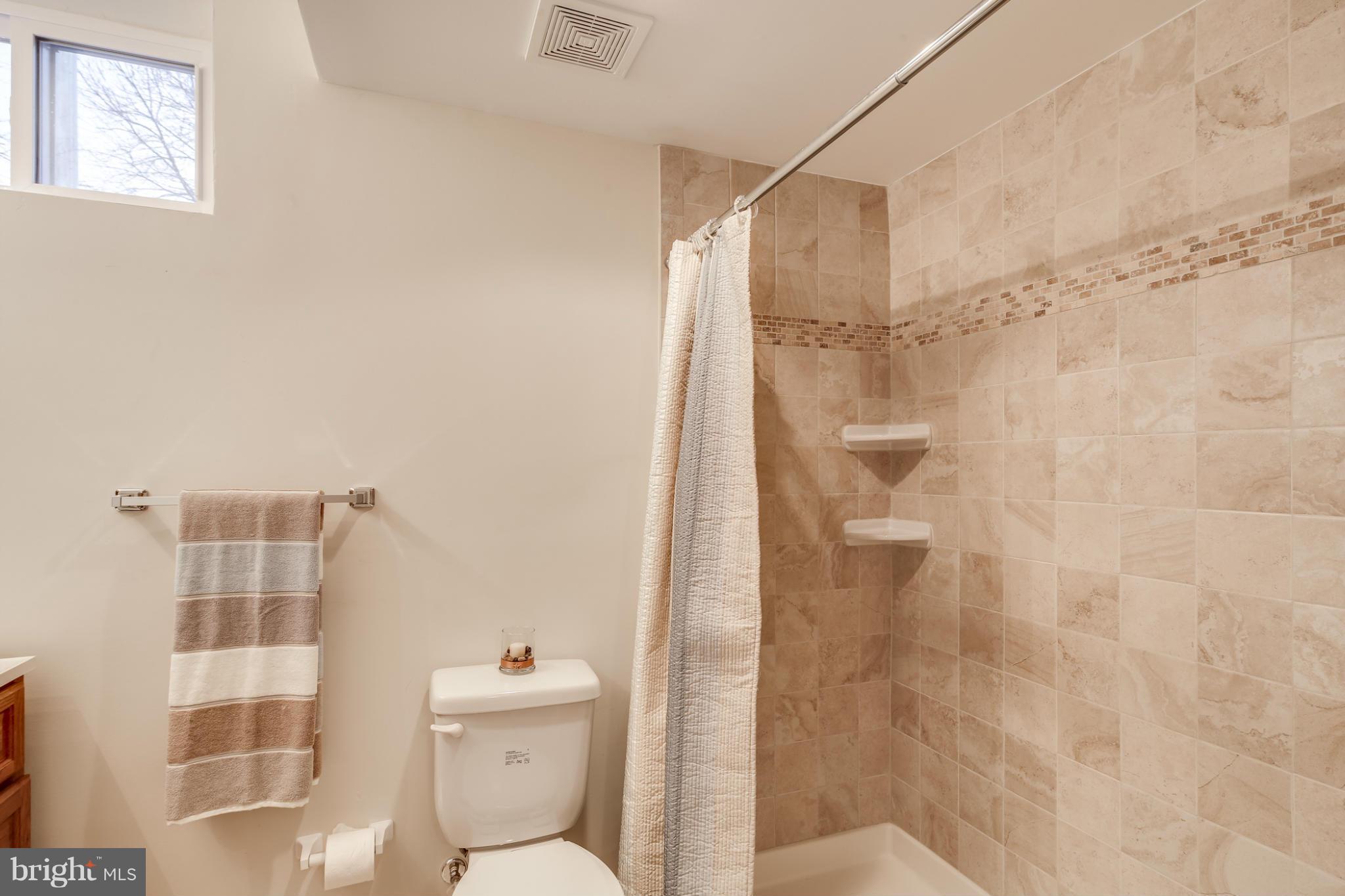 1315 Deanwood Road Baltimore, MD 21234 - Photo 16 of 30 a bathroom with a shower and toilet