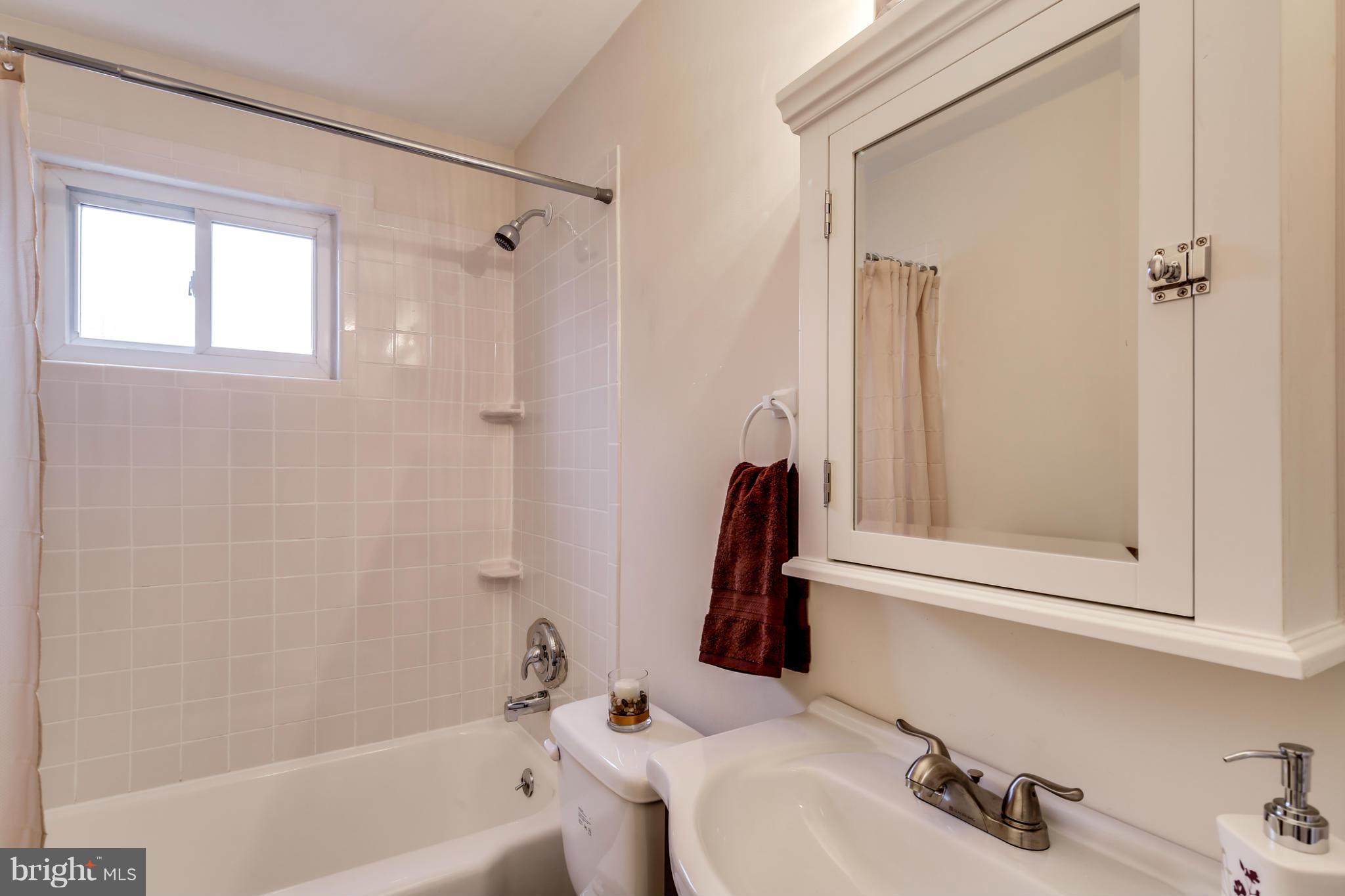 1315 Deanwood Road Baltimore, MD 21234 - Photo 21 of 30 a bathroom with a sink and a bathtub