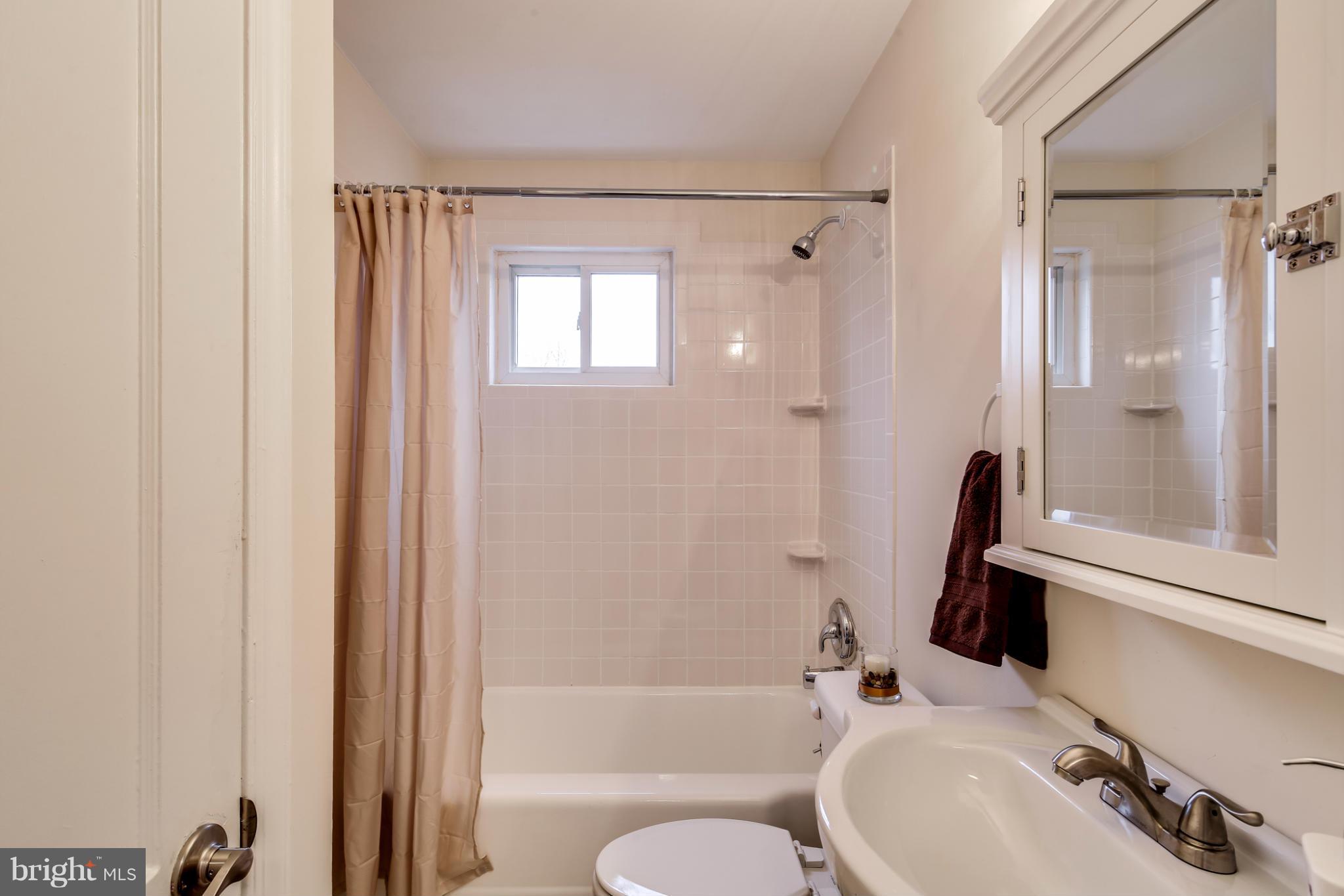 1315 Deanwood Road Baltimore, MD 21234 - Photo 22 of 30 a bathroom with a sink toilet and shower