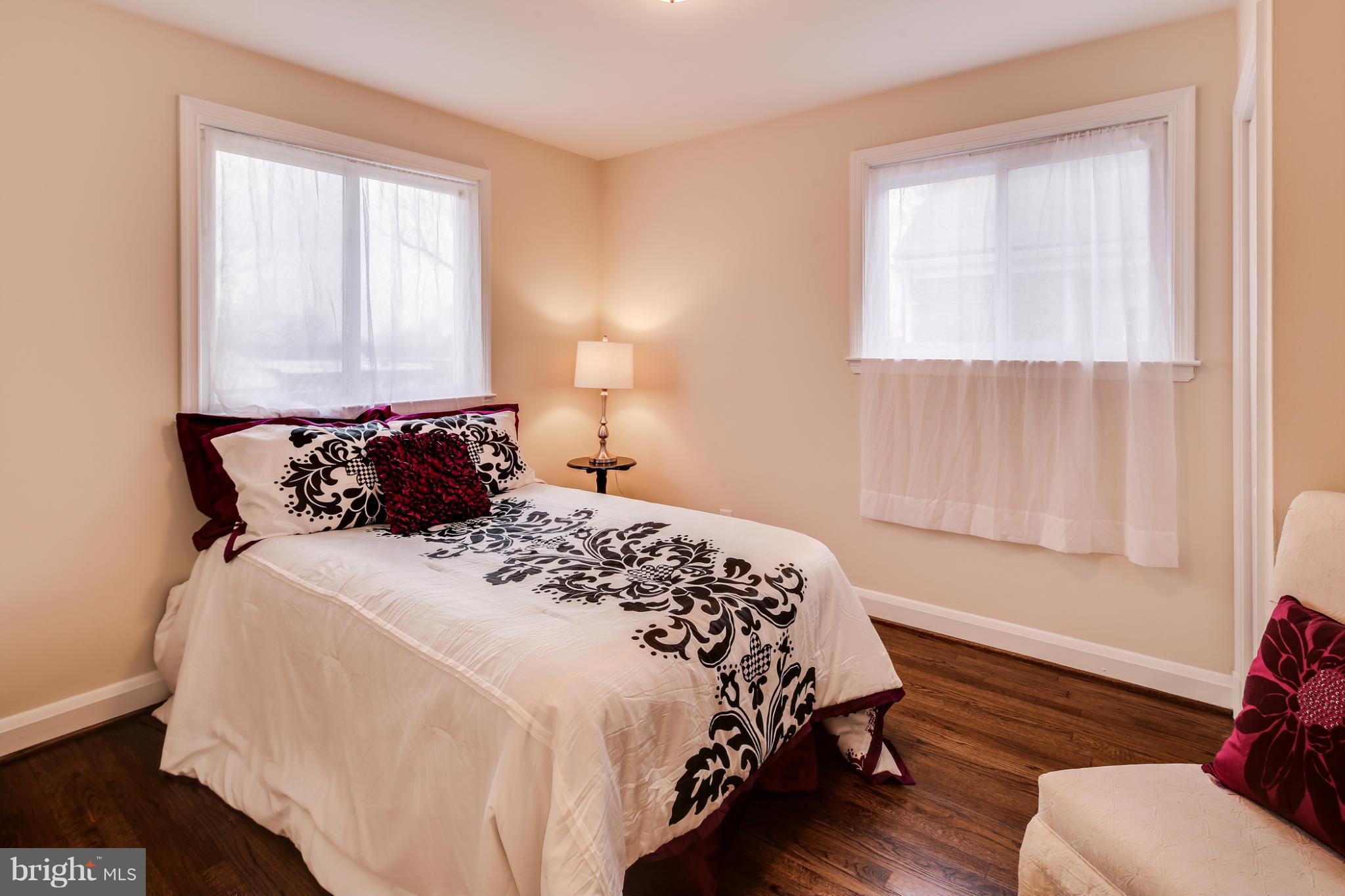 1315 Deanwood Road Baltimore, MD 21234 - Photo 23 of 30 a bedroom with a bed and wooden floor