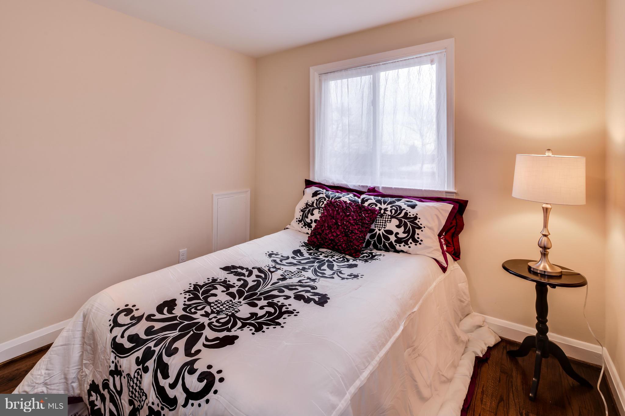 1315 Deanwood Road Baltimore, MD 21234 - Photo 25 of 30 a bed sitting in a bedroom next to a window