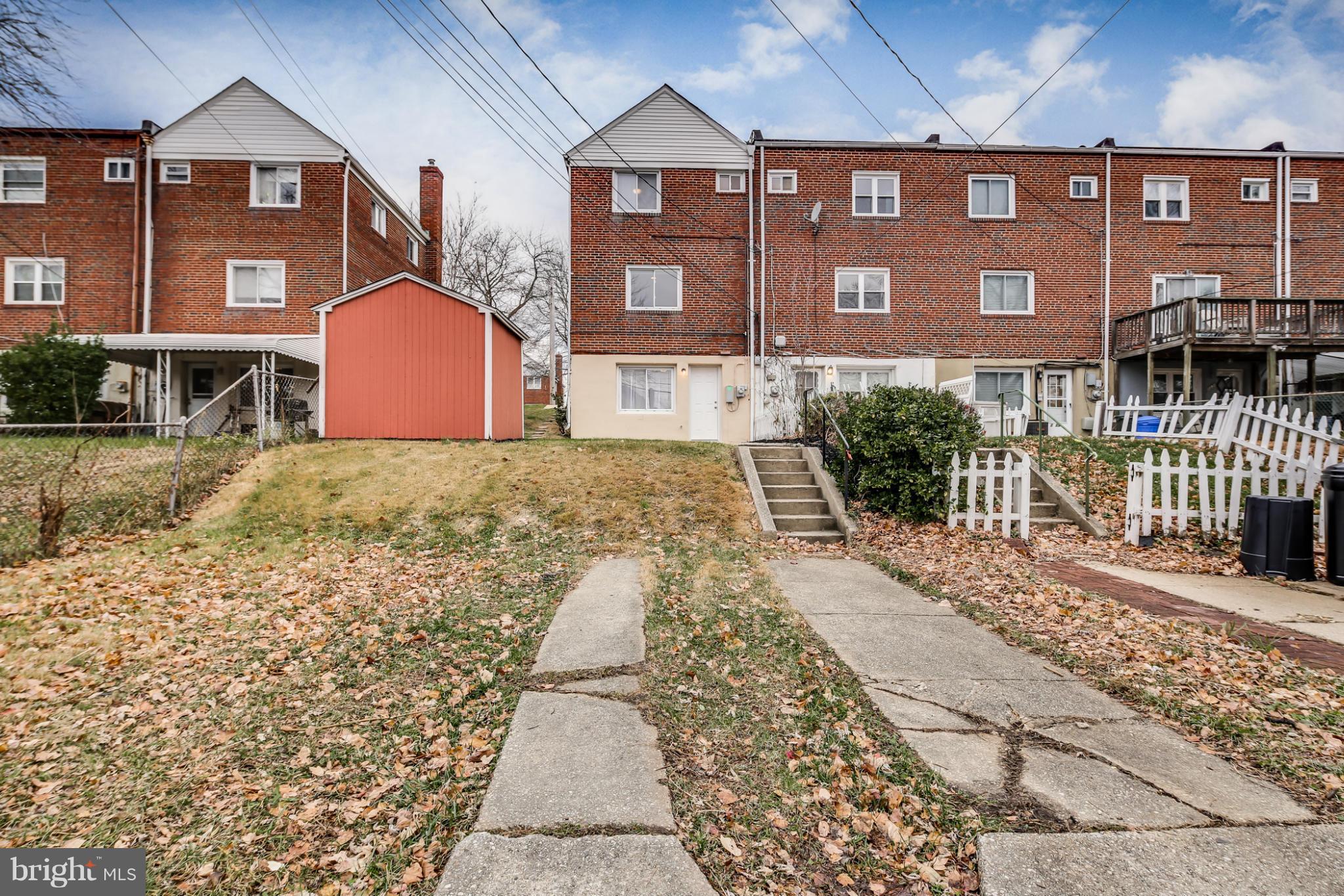 1315 Deanwood Road Baltimore, MD 21234 - Photo 28 of 30 a front view of a residential apartment building with a yard