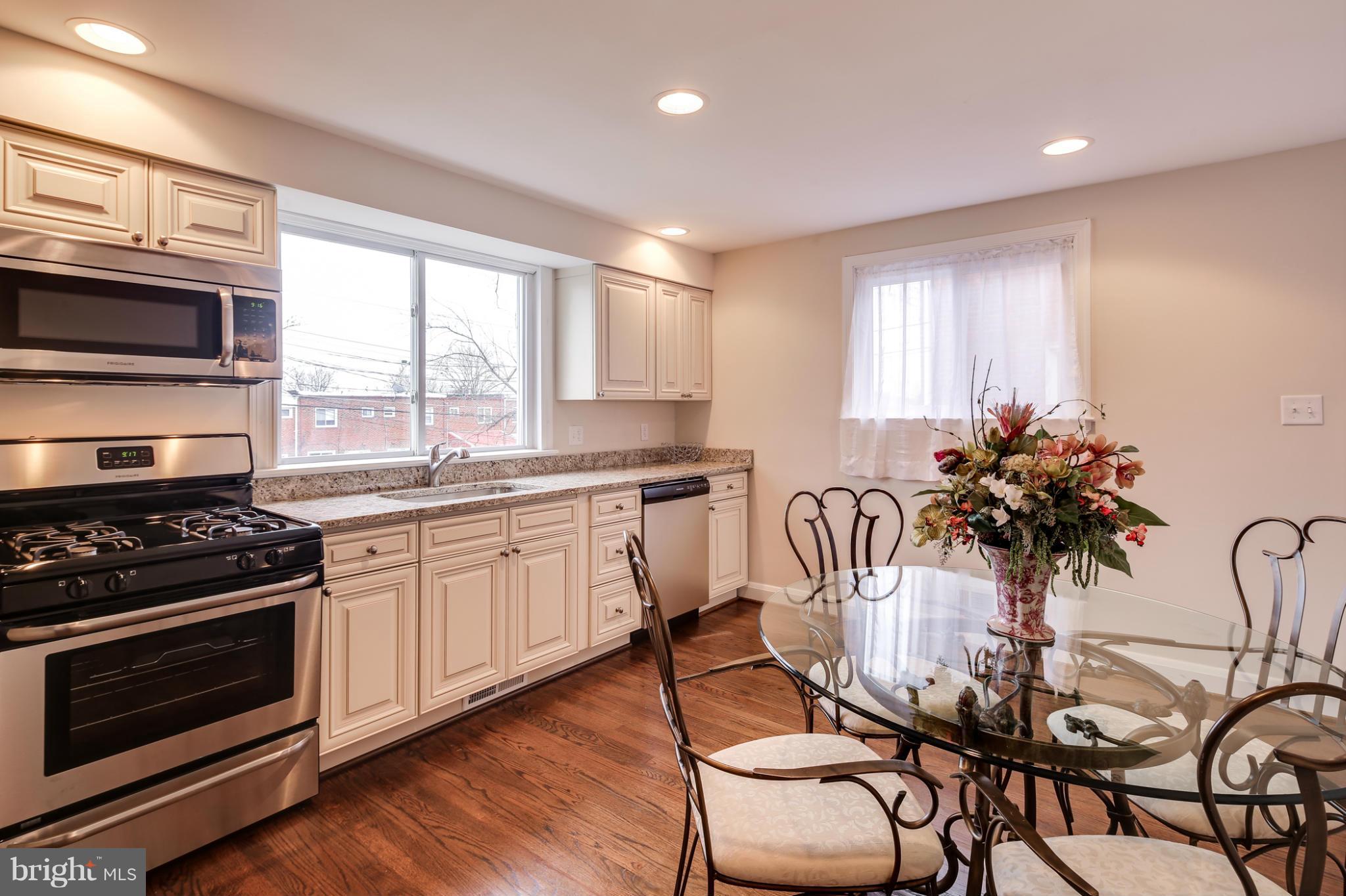 1315 Deanwood Road Baltimore, MD 21234 - Photo 5 of 30 a kitchen with granite countertop a stove a sink and a microwave
