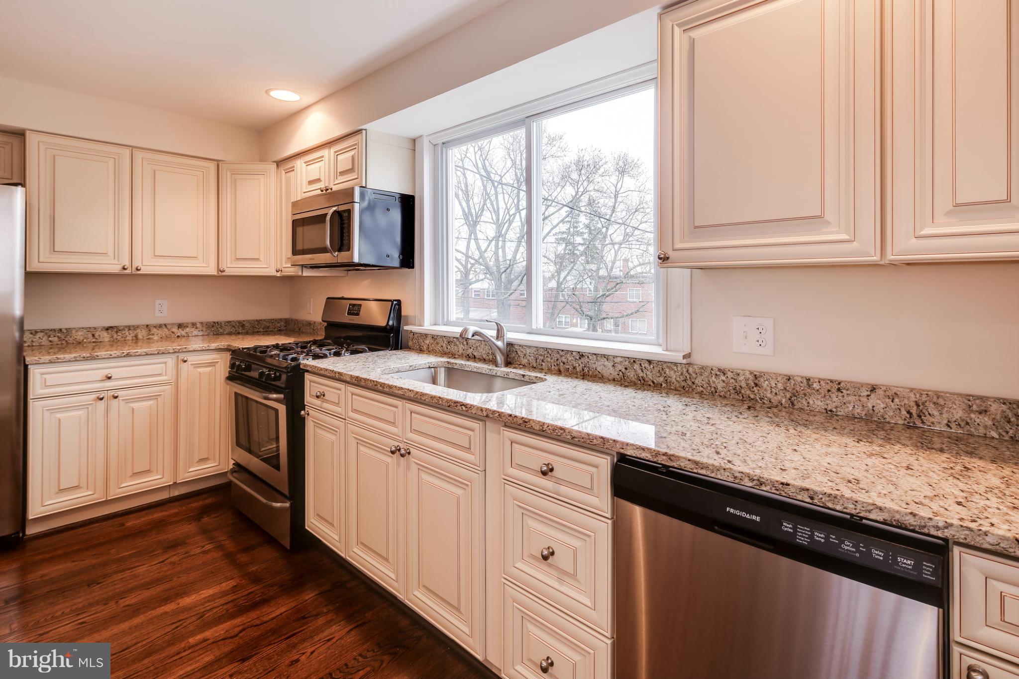 1315 Deanwood Road Baltimore, MD 21234 - Photo 7 of 30 a kitchen with granite countertop white cabinets and white appliances