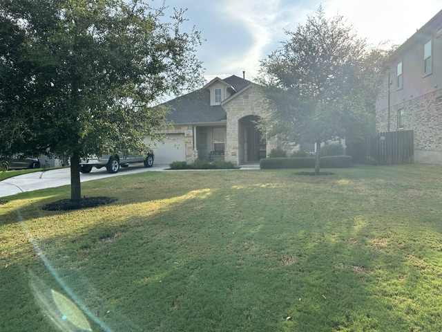 2313 Bridges Ranch Road Georgetown, TX 78628 - Photo 2 of 2 Mature trees shade the manicured lawn of this stone front residence.