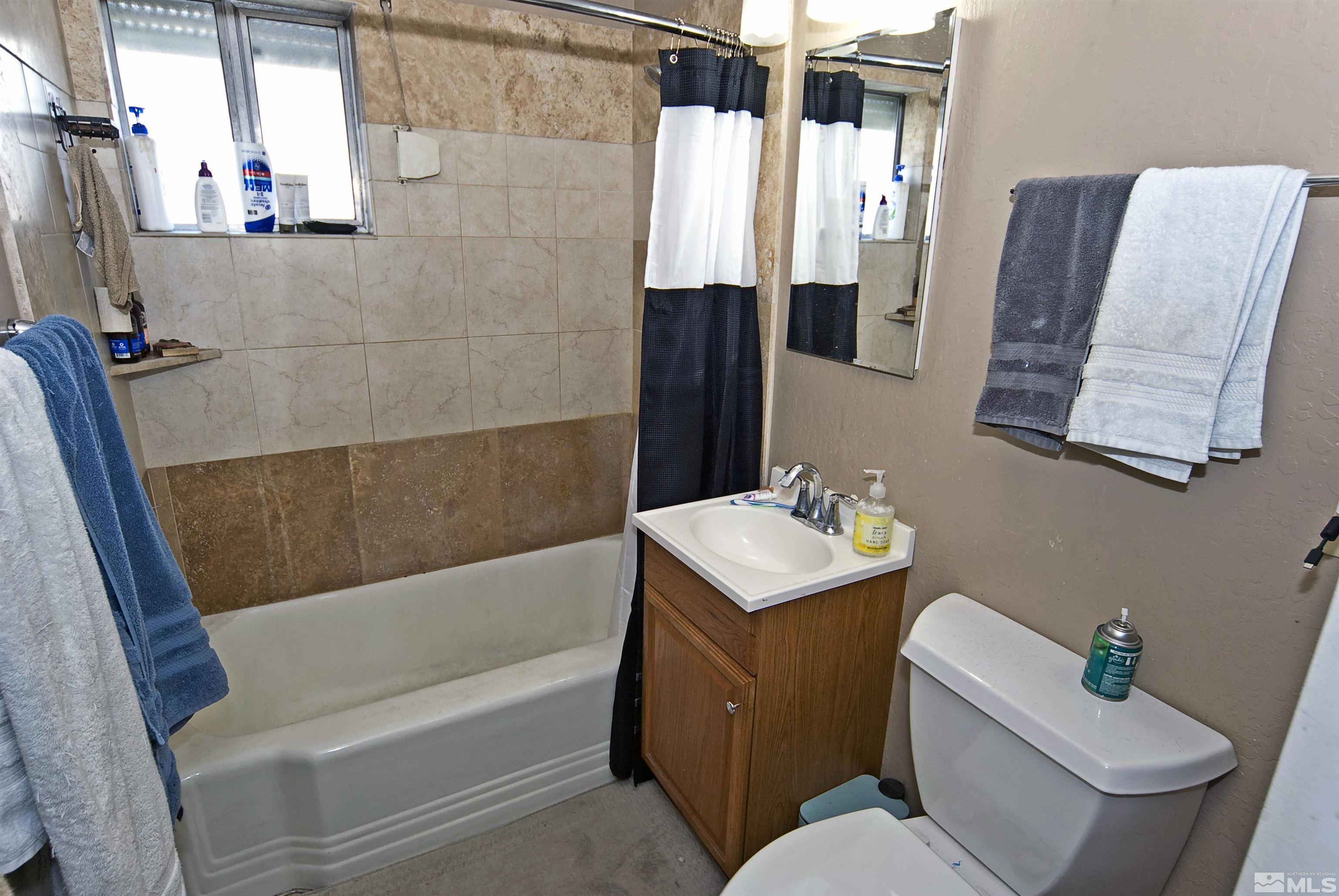 121 Bartlett Street Reno, NV 89512 - Photo 11 of 27 a bathroom with a sink toilet and shower