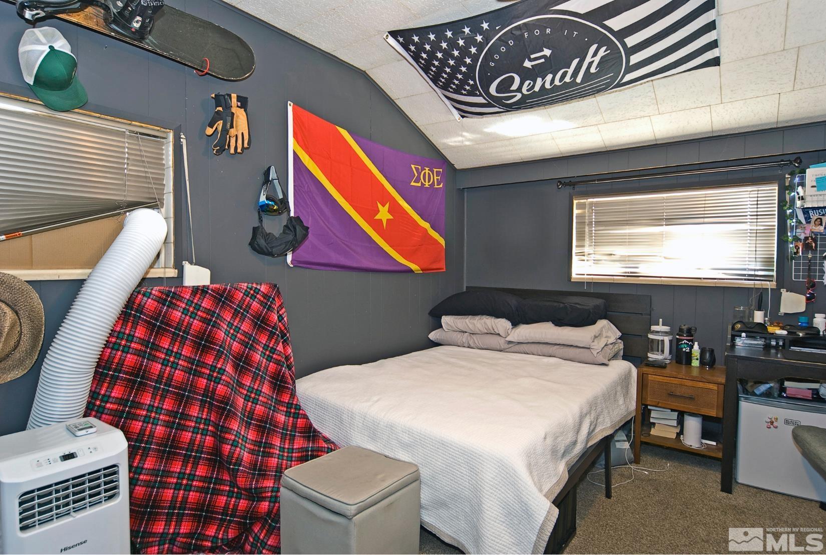 121 Bartlett Street Reno, NV 89512 - Photo 12 of 27 a bedroom with a bed and dresser next to a window