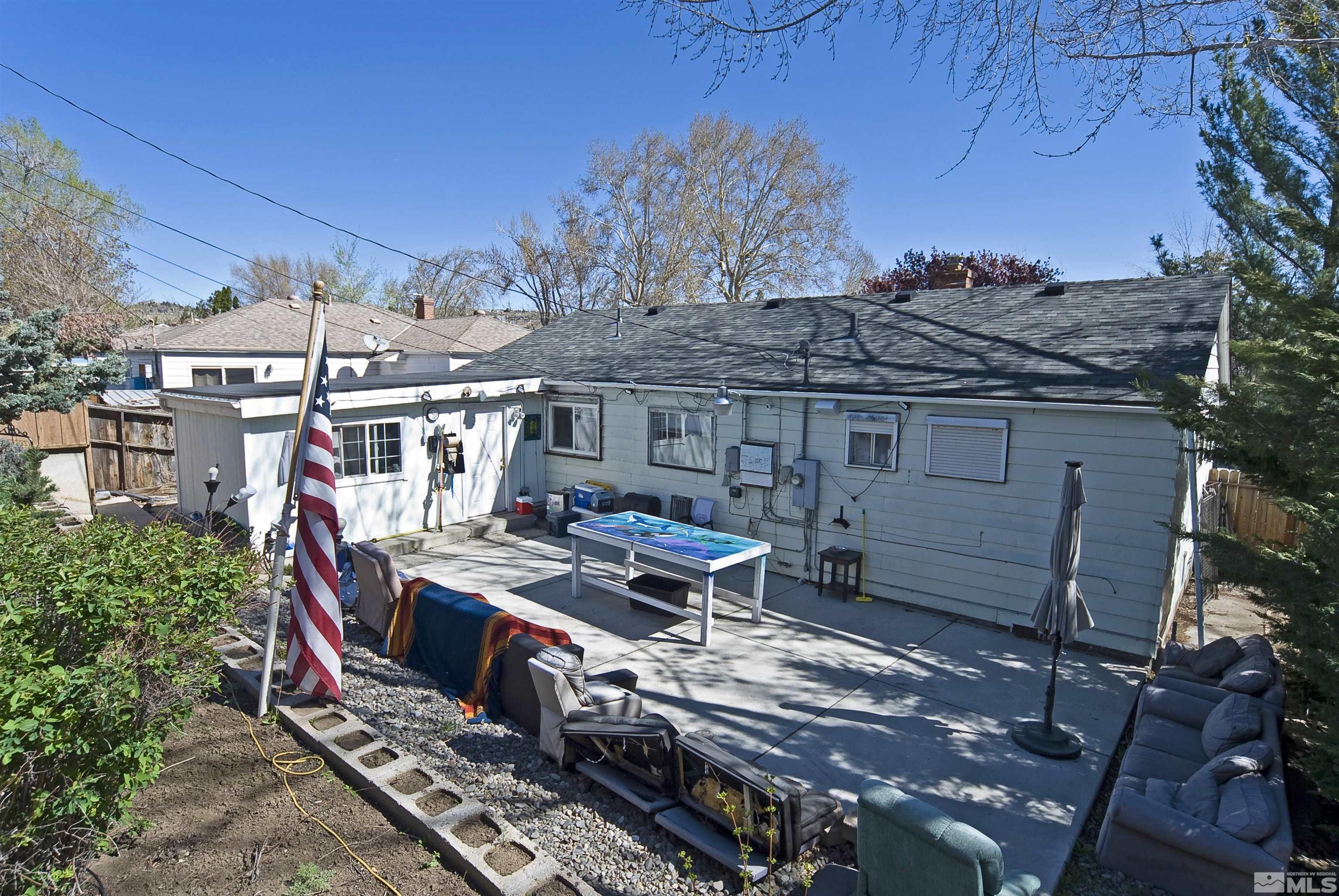 121 Bartlett Street Reno, NV 89512 - Photo 18 of 27 a view of a backyard with wooden deck and a patio