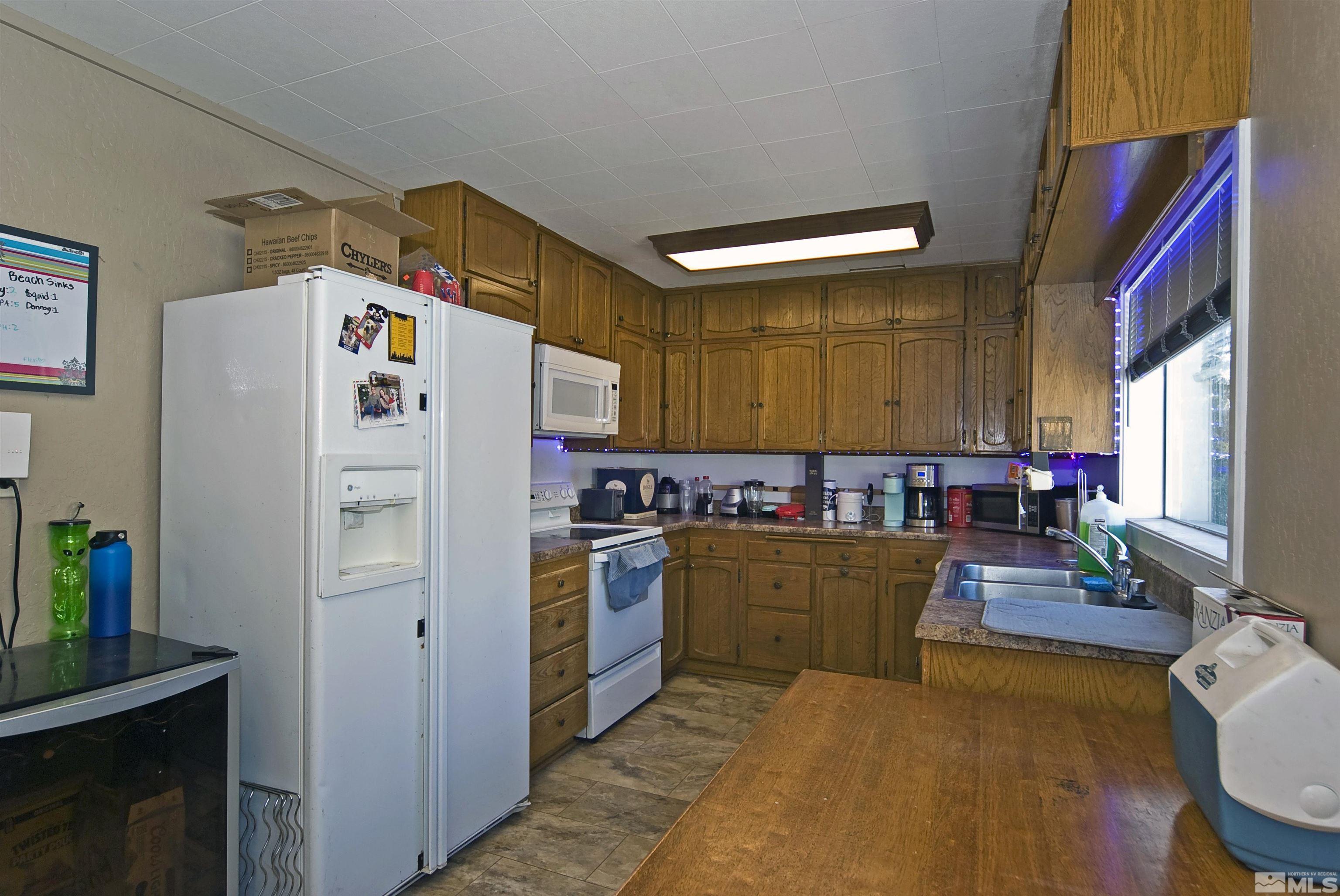 121 Bartlett Street Reno, NV 89512 - Photo 5 of 27 a kitchen with refrigerator and cabinets