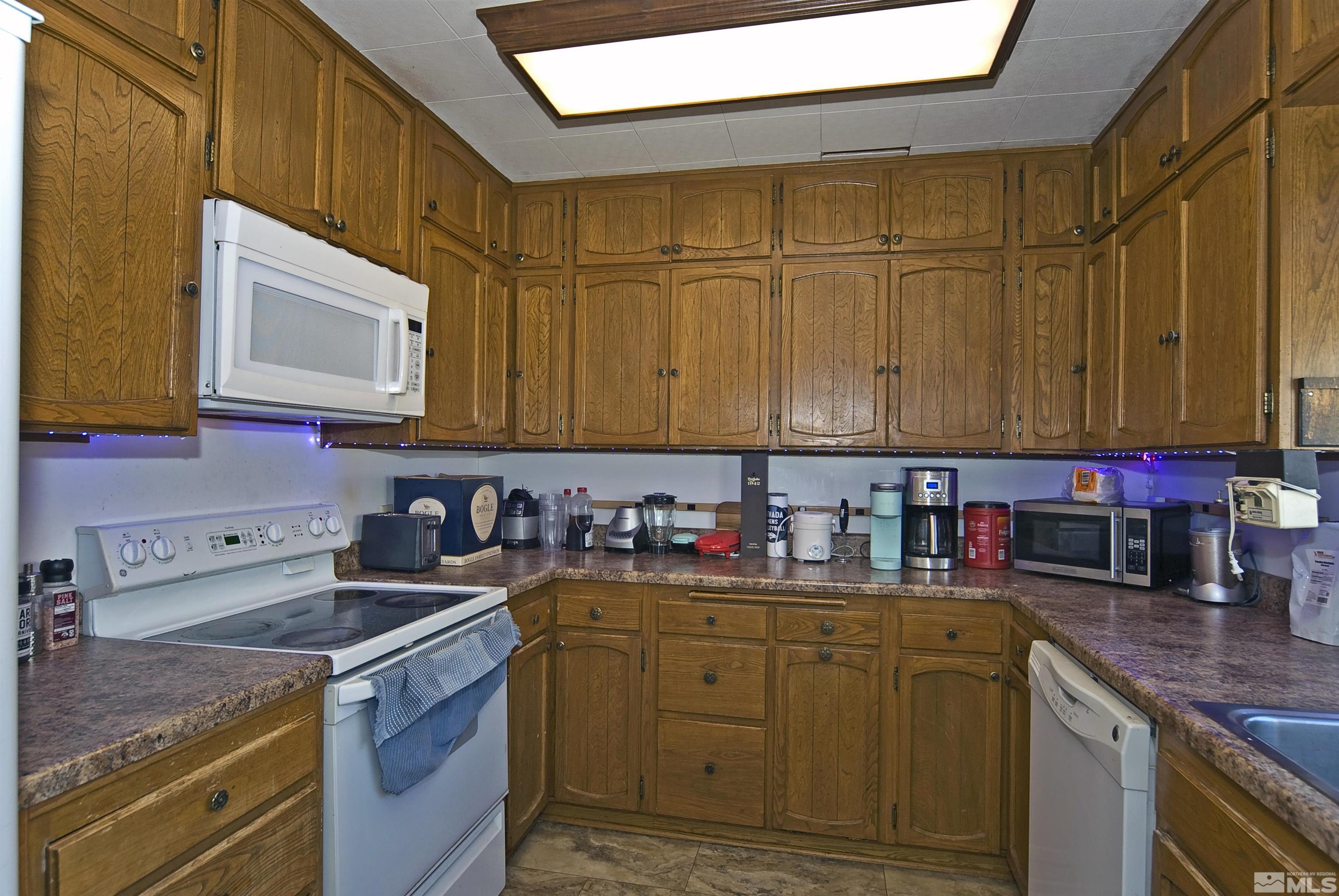121 Bartlett Street Reno, NV 89512 - Photo 6 of 27 a kitchen with stainless steel appliances granite countertop a sink a stove and cabinets