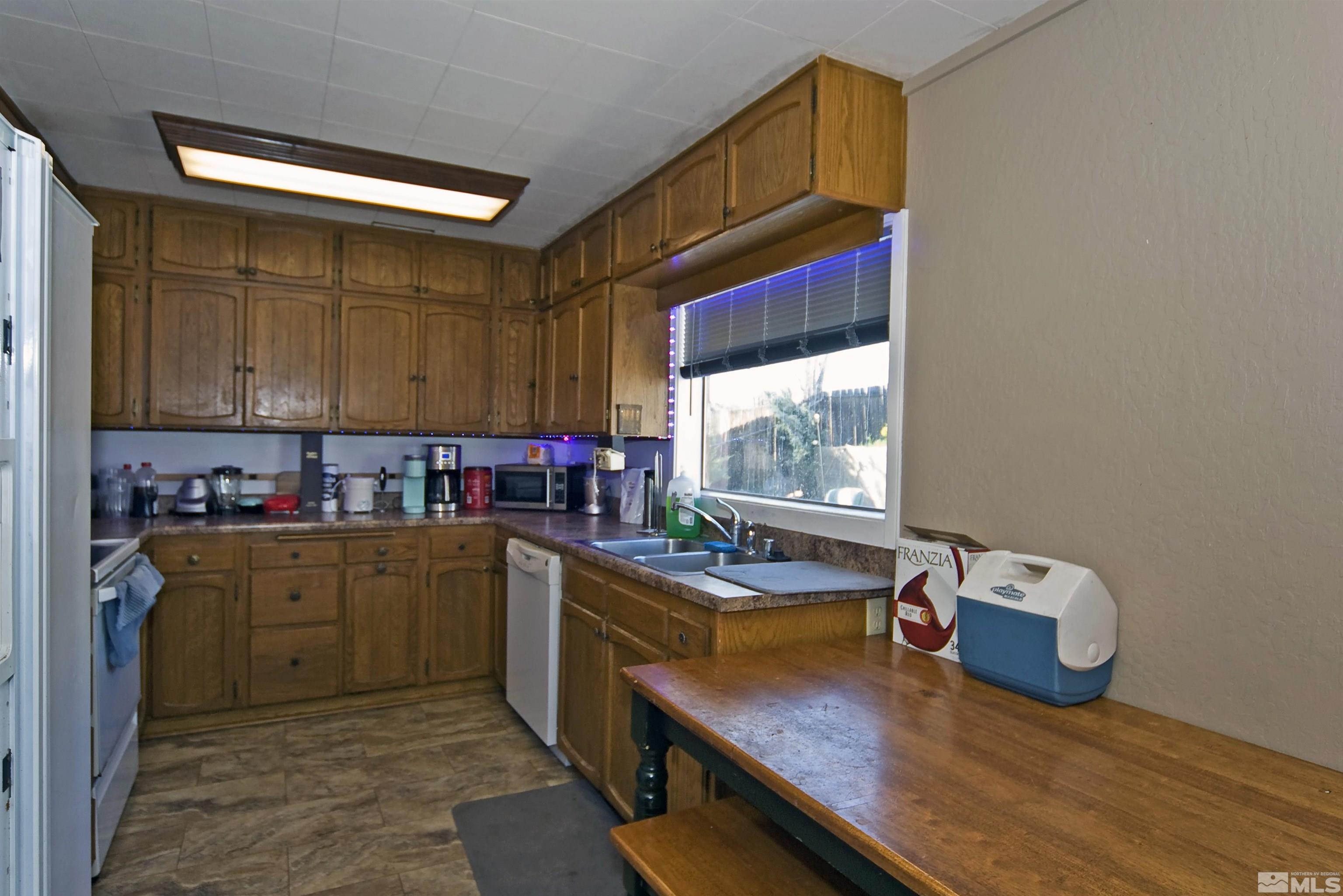 121 Bartlett Street Reno, NV 89512 - Photo 7 of 27 a kitchen with a sink cabinets and window