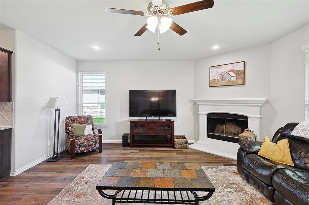 808 Feather Edge Drive Springtown, TX 76082 - Photo 21 of 40 a living room with furniture a flat screen tv and a fireplace