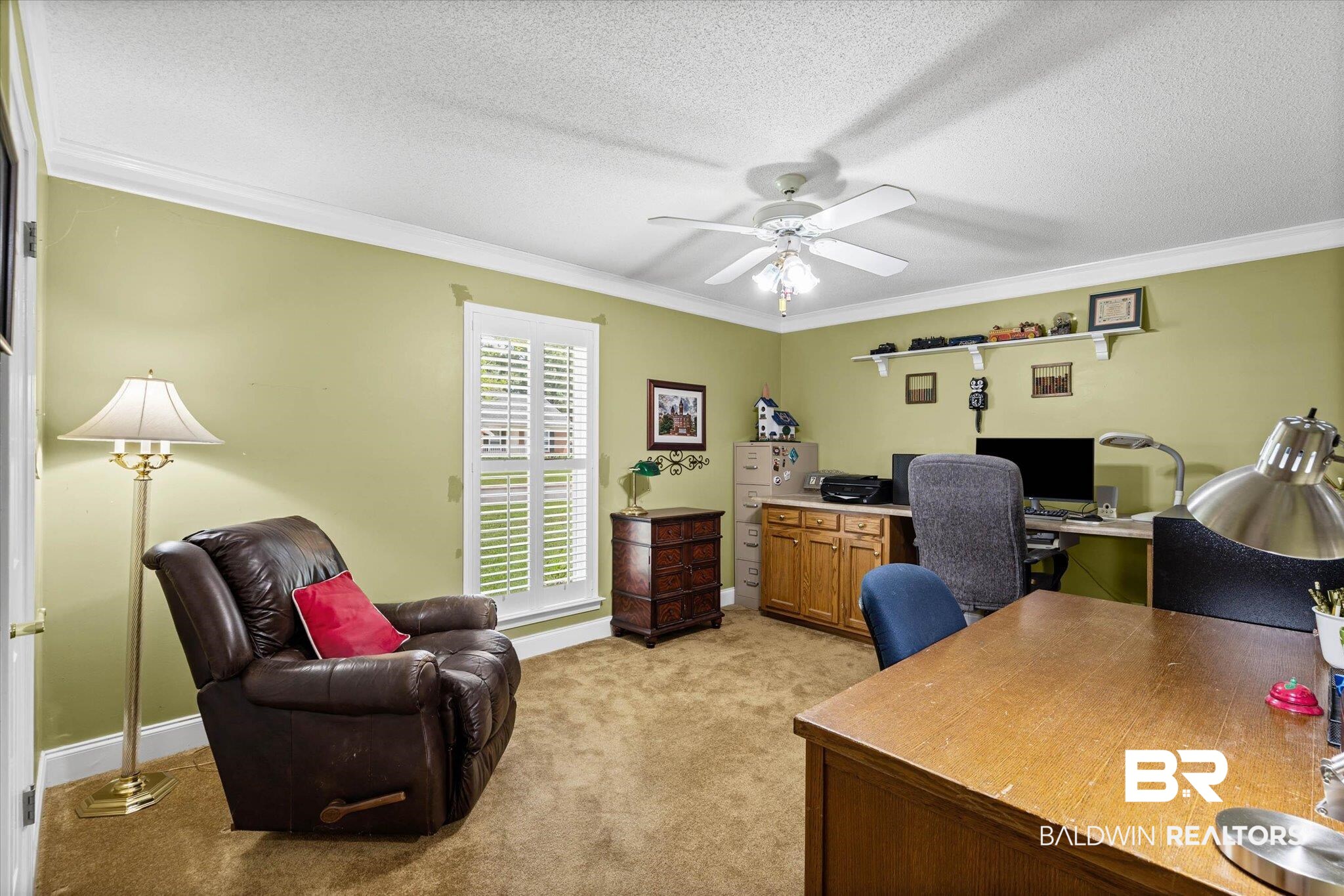 7410 Smithfield Road East Mobile, AL 36695 - Photo 17 of 24 Room featuring wall-to-wall carpeting, a window with plantation shutters, crown molding, and a ceiling fan with integrated lighting