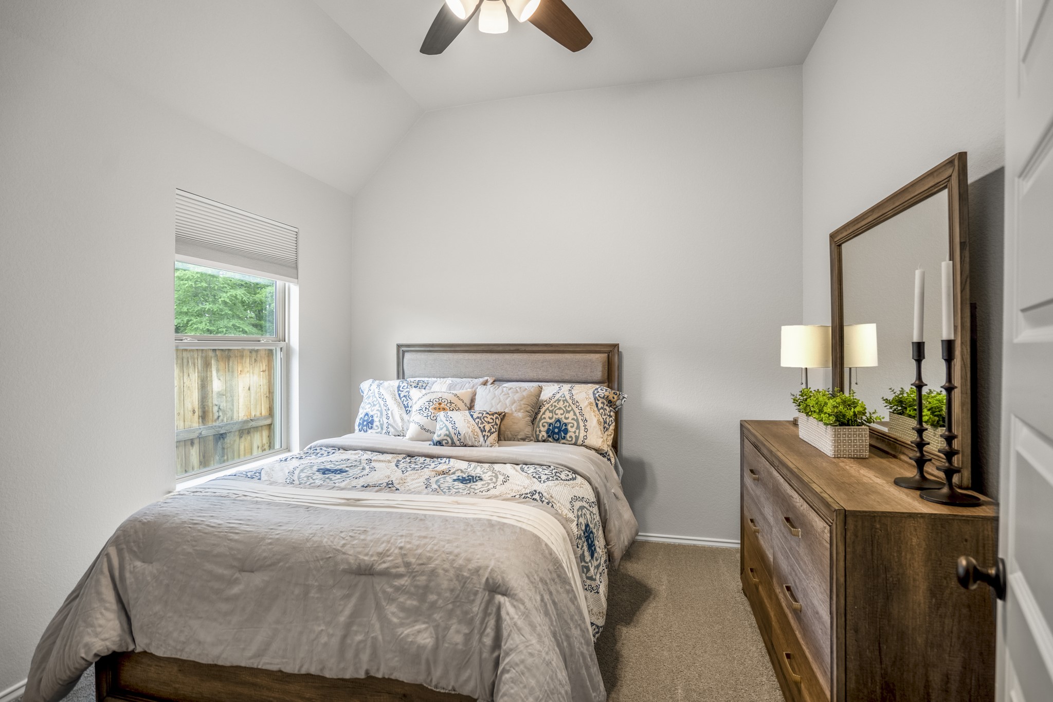 334 Topper Pines Drive Montgomery, TX 77316 - Photo 26 of 49 Off the alcove, the first secondary bedroom keeps things simple and comfortable, with soft carpet underfoot, a ceiling fan overhead, and natural light coming in from the backyard side of the home.