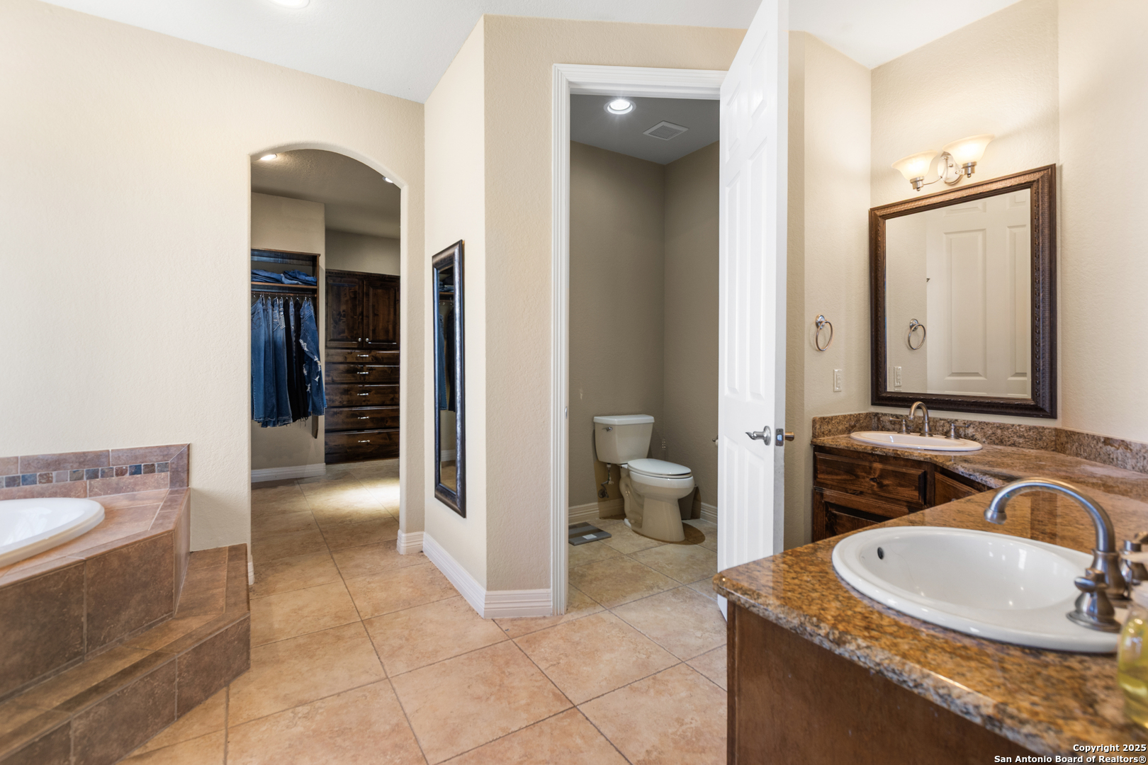 338 Tower Road San Antonio, TX 78223 - Photo 12 of 26 a bathroom with a granite countertop sink and a mirror