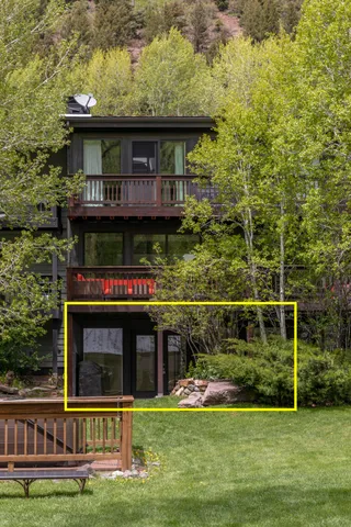 a view of a house with backyard and porch