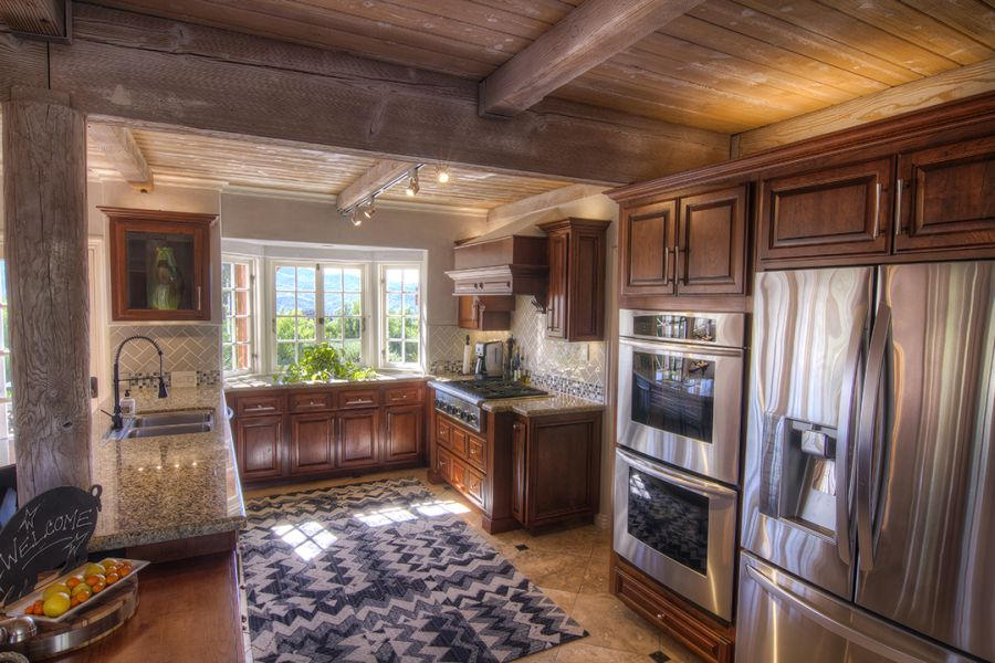 302 Fairview Road Ojai, CA 93023 - Photo 16 of 28 a kitchen with stainless steel appliances granite countertop a refrigerator a stove and a sink with large countertops